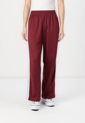 Maroon athletic pants with a loose fit and an elastic waistband, featuring light blue side panels and a smooth texture.
