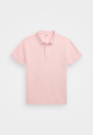 Polo shirt rosa claro feito de algodão, com mangas curtas, colarinho pontudo e um pequeno logótipo bordado no peito.