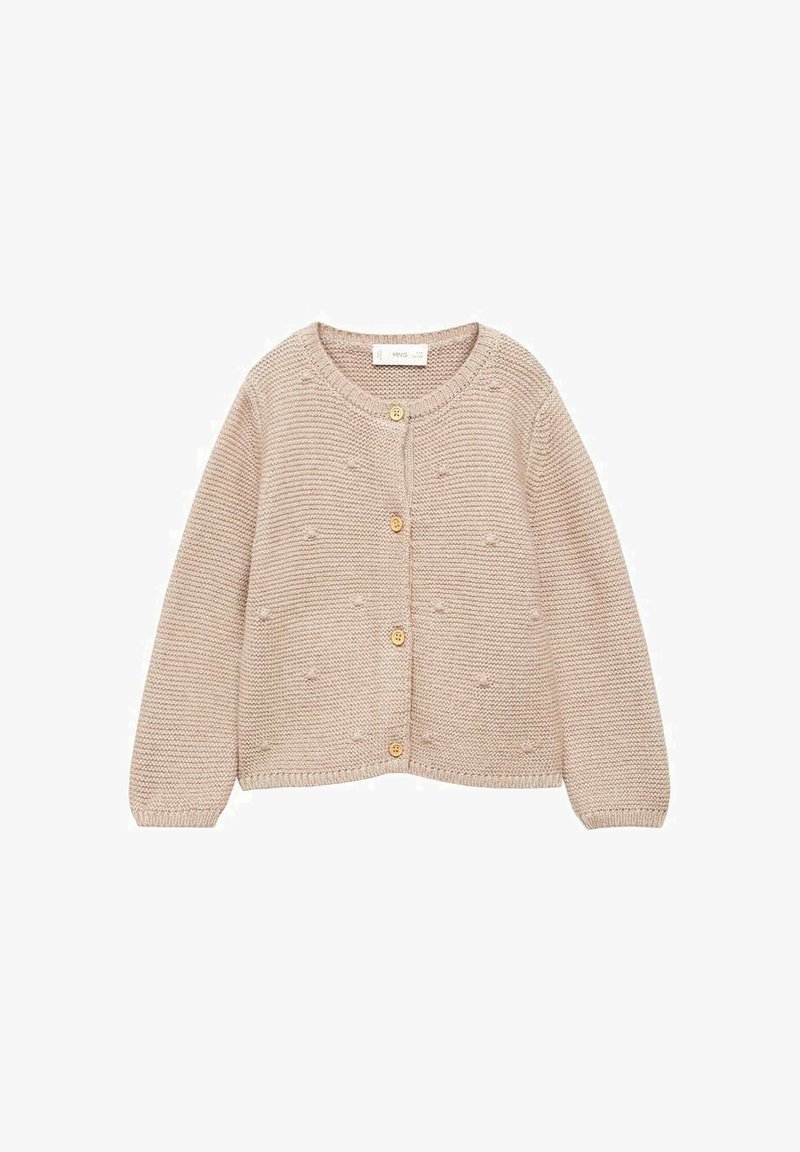 Beige neulottu neuletakki, jossa on pitkät hihat, pyöreä kaula-aukko ja viisi puusta valmistettua nappia. Lisäksi siinä on tekstuuripinta ja ribbaus hihansuissa sekä helman reunassa.