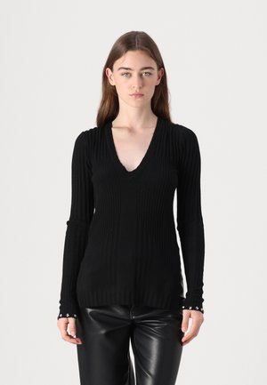 Black ribbed long-sleeve sweater with a V-neckline, featuring textured vertical lines and button accents on the cuffs.