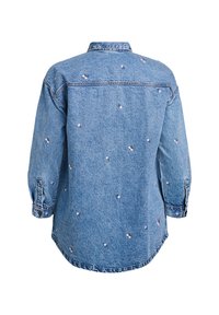 Denim shirt featuring a slightly relaxed fit, blue color, long sleeves, and embroidered floral designs throughout. Classic collar and button cuffs.