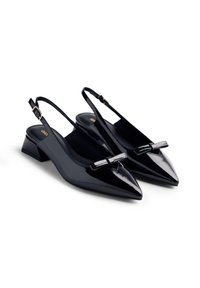 Black patent leather slingback shoes with a pointed toe, low block heel, and decorative bow detail on the front. Adjustable ankle strap included.