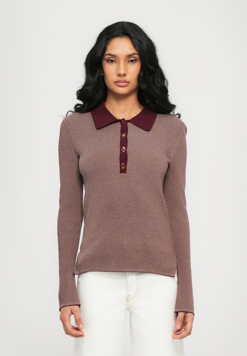 Long-sleeve ribbed sweater in mauve, featuring a maroon collar and five-button placket with decorative buttons. Textured fabric, fitted design.