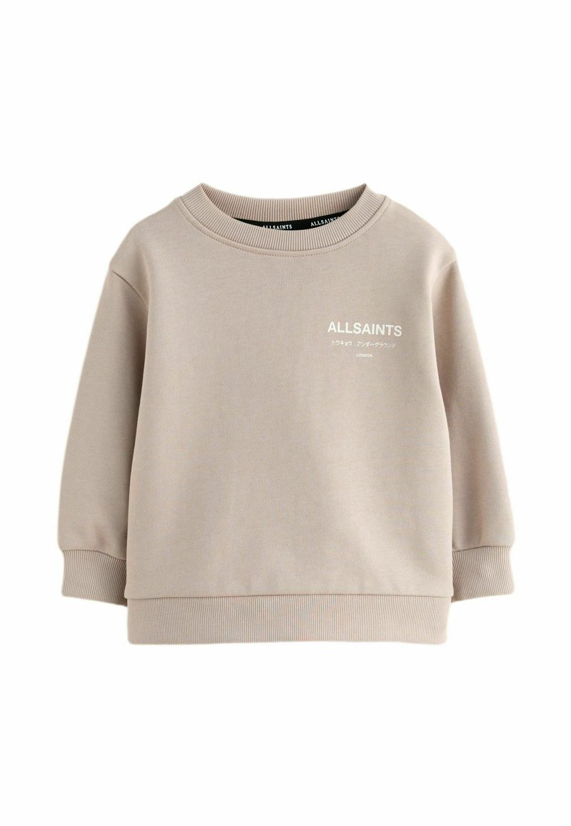 Felpa beige con colletto e polsini a coste. Presenta un logo frontale bianco. Realizzata in tessuto morbido e liscio. Design con vestibilità rilassata.