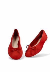 Bailarinas de ante rojo con punta redondeada y un detalle de lazo en la parte delantera. Textura suave y tacón bajo para mayor comodidad.