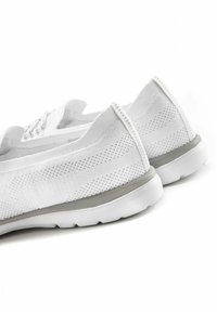 Sneaker bianche in rete caratterizzate da un design elegante, forma arrotondata, tomaia testurizzata e un accento grigio lungo la suola per un tocco di dettaglio in più.
