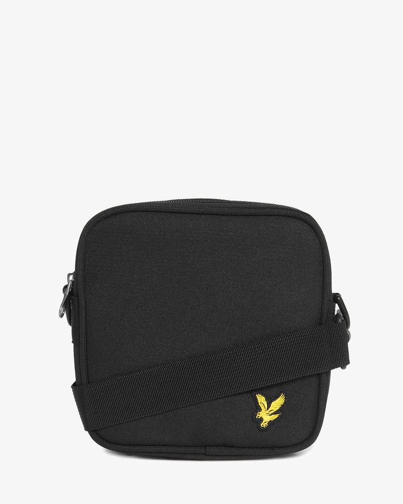 Mala compacta preta de tiracolo com alça ajustável e logótipo de pássaro amarelo bordado no canto inferior direito da frente.