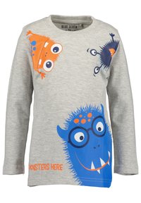Graues Langarmshirt mit Cartoons von Monstern in Blau und Orange. Mit runden Brillen, verspielten Designs und dem Text "MONSTER SIND HIER."