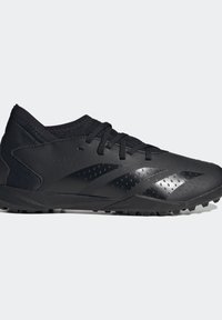 Svarta atletiska skor med en elegant design, syntetiskt material, texturerad ovandel och ett mönstrat svart sula med små knoppar för grepp.