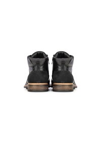 Botas de cuero negro hasta el tobillo con acentos de ante, cremalleras laterales y un tacón de madera apilado, con un acabado suave y texturizado.