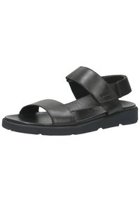 Sandales noires en cuir avec un design à bout ouvert, deux larges bandes et une boucle, reposant sur une semelle en caoutchouc noir texturé.