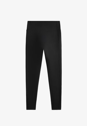 Schwarze Leggings aus einem glatten, dehnbaren Material. Sie haben einen hohen Bund und seitliche Nähte, mit einem enganliegenden Design bis zum Knöchel.