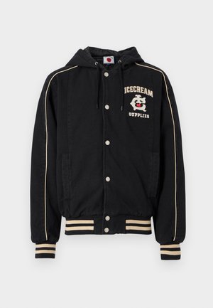 Veste noire à capuche avec accents blancs, boutons-pression et deux poches latérales. Présente un motif "ICECREAM SUPPLIES" sur la poitrine. Matière en mélange de coton.