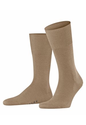 Tan cotton blend socks with a ribbed cuff, smooth texture, and reinforced toe. Features subtle branding on the sole.