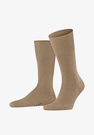 Tan cotton blend socks with a ribbed cuff, smooth texture, and reinforced toe. Features subtle branding on the sole.