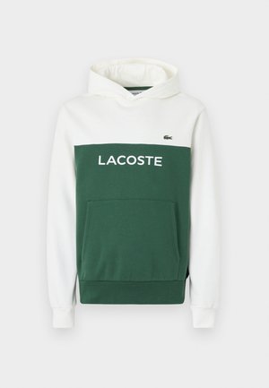 Hoodie vert et blanc avec une poche kangourou, arborant "LACOSTE" en lettres majuscules sur la poitrine et un logo brodé en haut à gauche.