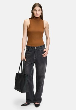 Brown ribbed turtleneck top, baggy faded black jeans, black tote bag, and pointed black heels. Smooth textures and casual fit.