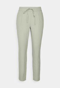 Jasnozielone lniane spodnie z elastycznym paskiem i sznurkiem, z tapered leg designem i miękką fakturą.