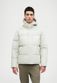 Casaco puffer cinza claro com gola alta e capuz, apresentando um fecho frontal com zíper, bolsos laterais e um padrão texturizado subtil.