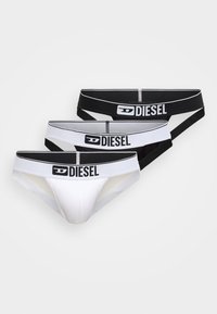 Tres pares de calzoncillos Diesel en blanco y negro, con cinturillas elásticas con el logo, textura suave y diseño de corte clásico.