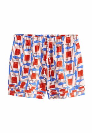 Laste lühikesed püksid valge taustaga ning mustriga, kus on siniseid kalu ja punaseid ruute vertikaalsetes triipudes.