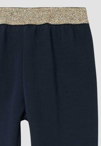 Marineblauwe leggings met een glitterende gouden tailleband, gemaakt van een zachte stof, met een gladde textuur en een aansluitend ontwerp.