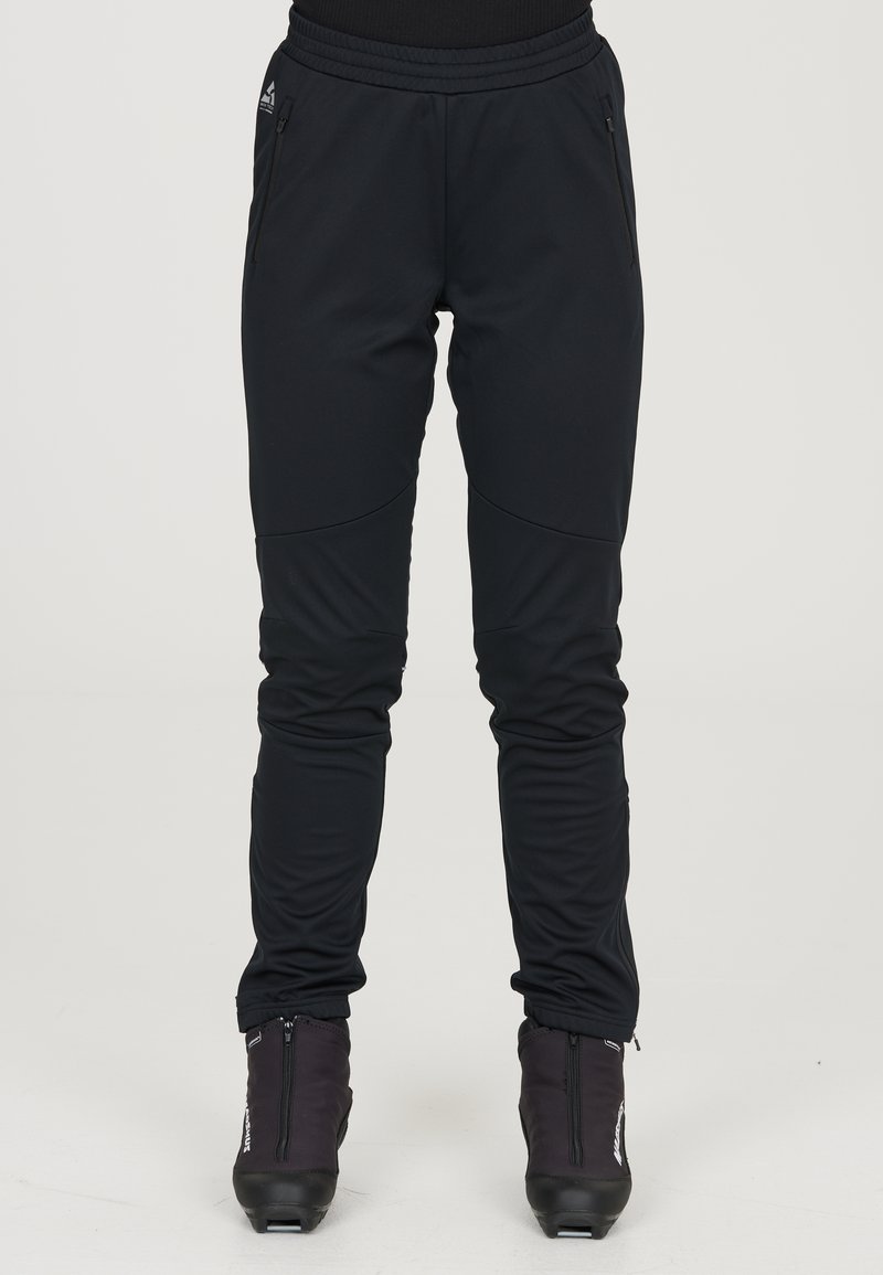 Mustat urheiluhousut, jotka on valmistettu venyvästä synteettisestä materiaalista. Niissä on tiukka muotoilu, vetoketjulliset taskut ja kapeat lahkeet, jotka takaavat mukavan istuvuuden.