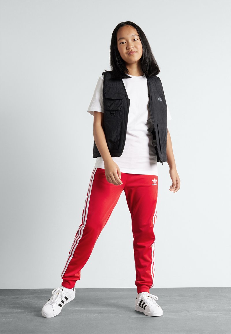 adidas Originals TRACK PANTS UNISEX - Tracksuit bottoms - better  scarlet/red 