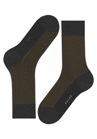 Chaussettes gris foncé avec un motif de points orange. Présentent un poignet côtelé et une texture lisse. Le nom de la marque "FALKE" est imprimé sur une chaussette.