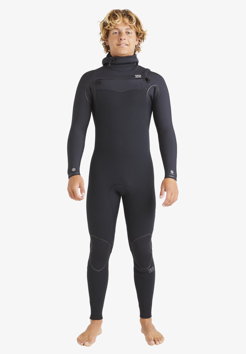 Black wetsuit with long sleeves, high collar, and smooth texture. Features reinforced knee pads and subtle brand logo on chest.