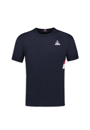 T-shirt en coton bleu marine à manches courtes, col rond, avec un petit logo sur la poitrine gauche. Présente des accents de color block sur le côté.