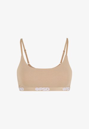 Bralette beige yang terbuat dari kain lembut dengan tali yang dapat disesuaikan. Memiliki pita merek putih di bagian bawah. Tekstur halus, desain sederhana.