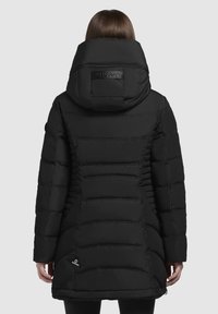 Svart puffjacka med stor huva, med en kviltad design, sidofickor och en märkt etikett på baksidan. Slät, glänsande textur.