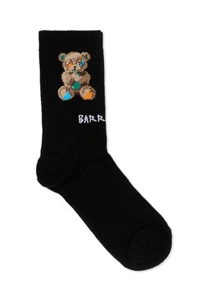 Zwarte sok met een gestikte teddybeer met meerkleurige stukjes en gedeeltelijke witte tekst "BARB" nabij de enkel.