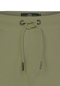 Lichtgele sweatpants met een geribde tailleband, verstelbaar trekkoord en metalen accenten. Voorzien van zijzakken en een gladde stoftextuur.