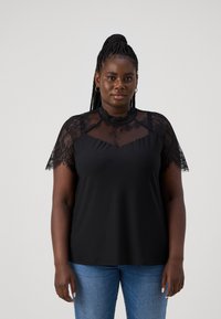 Black top featuring lace short sleeves and a sheer lace neckline, paired with blue jeans. The fabric appears smooth and lightweight.