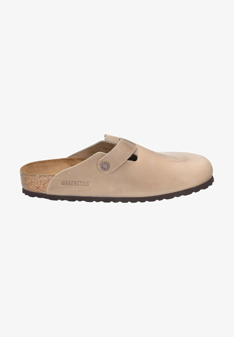 Beige Birkenstock klumpissa, joka on valmistettu sametista ja jossa on korkkipohja, edessä on hihna ja pintarakenteellinen kumipohja.