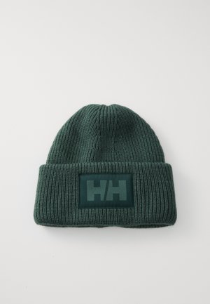 Green knitted beanie with a folded cuff, featuring a rectangular logo patch in darker green displaying initials "HH." Textured ribbed pattern.