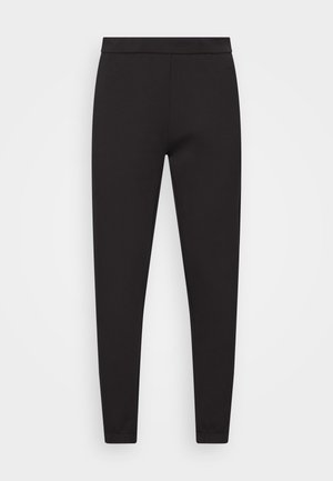 Svarta joggingbyxor i ett slätt, stretchigt material. Har en platt midja, tapered avslut och inga synliga fickor eller mönster.