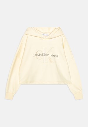 Roomkleurige cropped hoodie met lange mouwen en geribbelde manchetten, voorzien van geborduurde "Calvin Klein Jeans" en een groot "CK"-logo aan de voorkant.