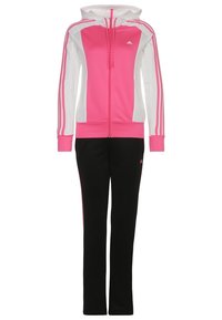 Veste à capuche zippée rose et blanche avec trois bandes sur les manches, associée à un pantalon noir avec de fines bandes roses.