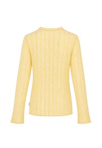 Haut en dentelle jaune à manches longues avec bords festonnés au col et aux poignets, vu de dos sur fond blanc.