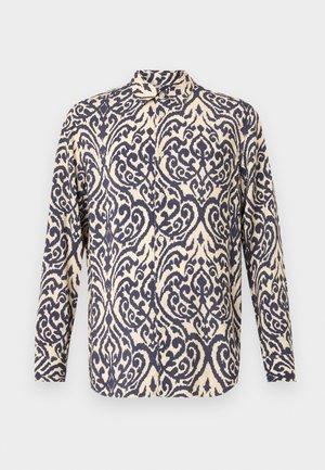 Srajca z dolgimi rokavi v kremni barvi z zapletenimi navy modrimi vijugastimi vzorci, s ovratnikom in zapiranjem na gumbe.