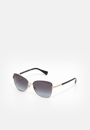Sunglasses with a gold metal frame, black arms, and gradient gray lenses. Angled shape with prominent corners and logo detail on arms.