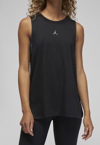 Black sleeveless athletic tank top with round neckline, made of soft cotton, featuring a small white Jordan logo on the chest.
