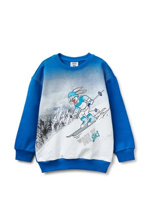 Sweat-shirt bleu avec un lapin de dessin animé en train de skier, portant des lunettes et un équipement, descendant une pente enneigée, avec le texte "WAKE UP FOR Ski."