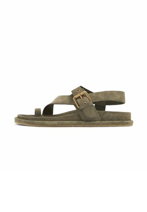 Olive green suede flat sandal with toe loop, wide strap crossing foot, and adjustable gold buckle ankle strap, on a flat sole.