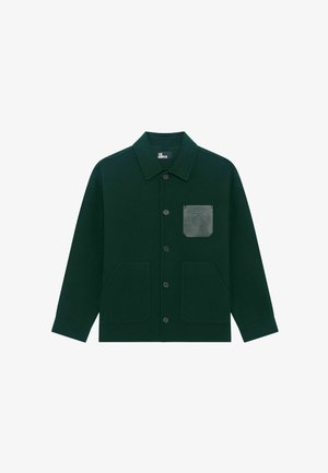 Dark green button-up jacket with three front pockets, including a leather-textured chest pocket embossed with a circular emblem.