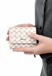 Compact wallet in light gray patterned fabric with geometric design; features a clasp closure and subtle brand logo on the front.