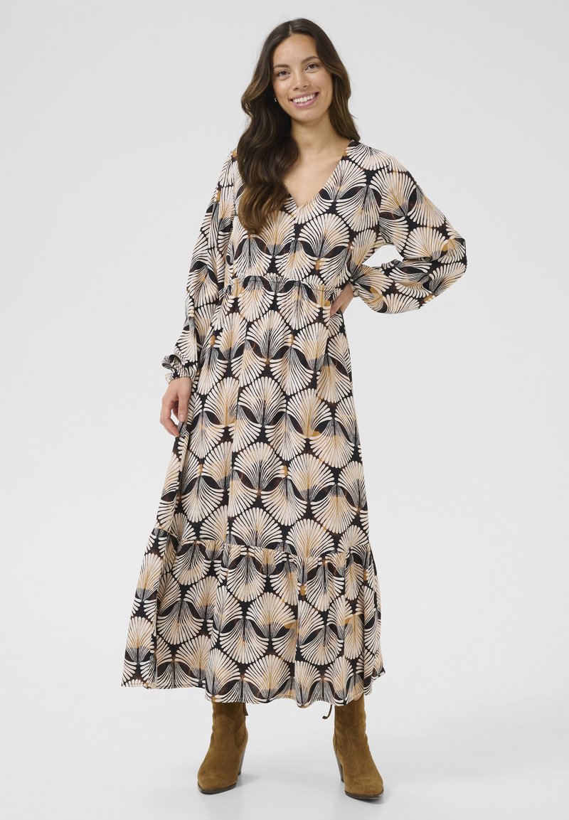 Maxikleid mit tiefem V-Ausschnitt, langen Ärmeln und geschichtetem Saum. Hat einen schwarzen Grundton mit beigen und goldenen blattähnlichen Mustern.